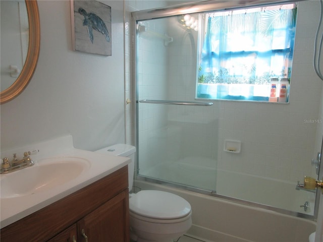 full bathroom featuring vanity, toilet, and enclosed tub / shower combo