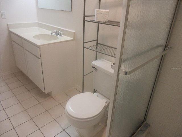 bathroom featuring tile patterned flooring, toilet, vanity, and a stall shower