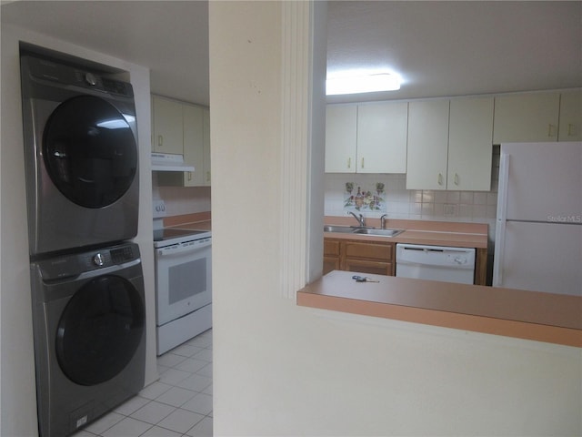 kitchen with a sink, light tile patterned flooring, stacked washer / dryer, white appliances, and under cabinet range hood