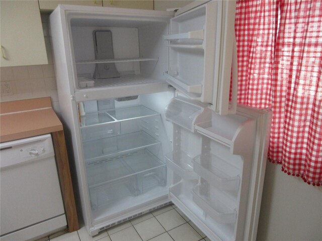 room details with dishwasher, light countertops, and fridge