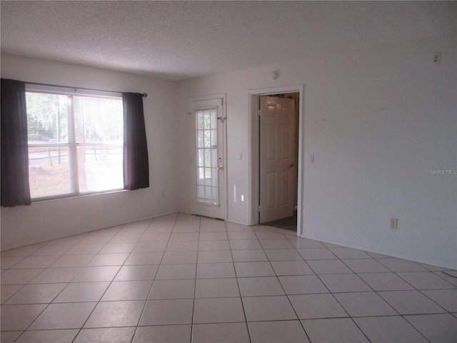 unfurnished room with a textured ceiling