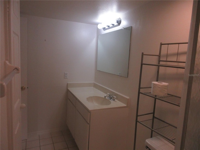 bathroom featuring vanity, tile patterned flooring, and toilet
