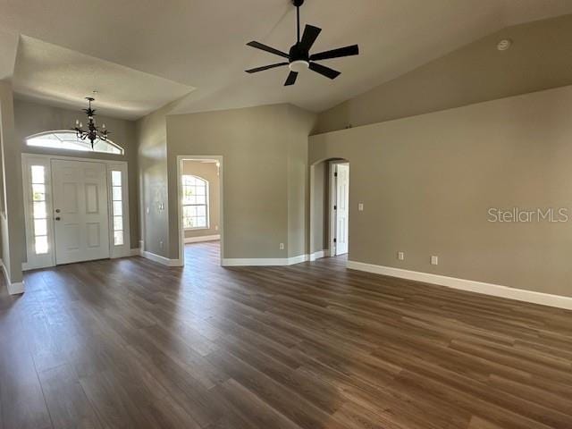 9934 SE 64th Ave, Belleview, FL 34420 - foyer featuring ceiling fan with notable chandelier, high vaulted ceiling, arched walkways, dark wood-style flooring, and baseboards