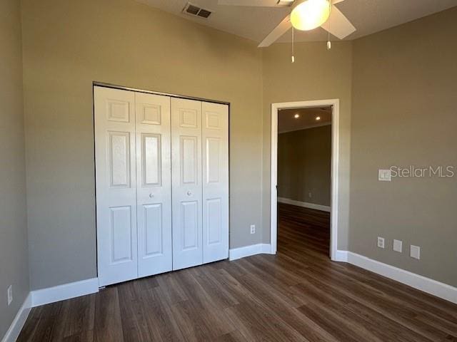 9934 SE 64th Ave, Belleview, FL 34420 - unfurnished bedroom featuring dark wood-style flooring, visible vents, baseboards, and a closet