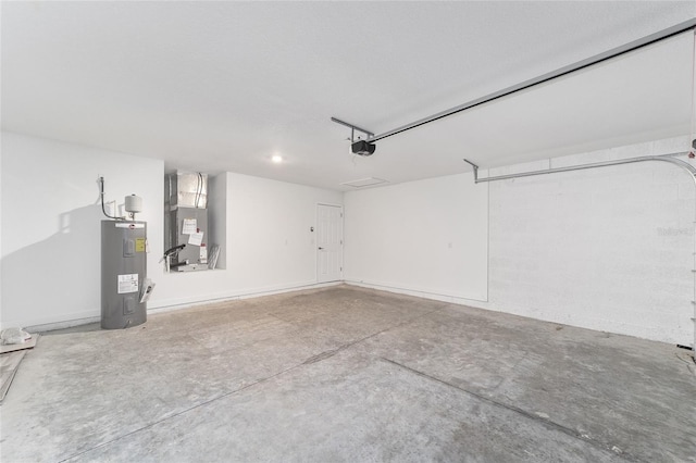 garage featuring a garage door opener, heating unit, and water heater