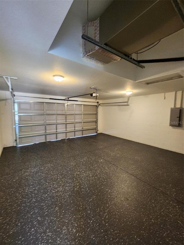 garage featuring a garage door opener and electric panel