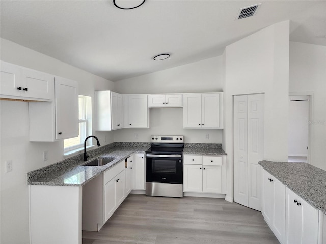 22764 SW Sea Cliff Ave, Dunnellon, FL 34431 - kitchen with a sink, stainless steel electric range, stone countertops, white cabinetry, and lofted ceiling