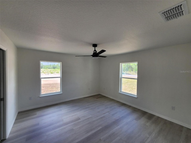 22764 SW Sea Cliff Ave, Dunnellon, FL 34431 - spare room with plenty of natural light, wood finished floors, a ceiling fan, baseboards, and a textured ceiling