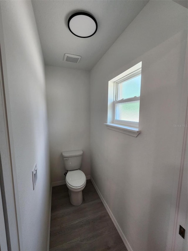 22764 SW Sea Cliff Ave, Dunnellon, FL 34431 - bathroom with wood finished floors, toilet, and baseboards