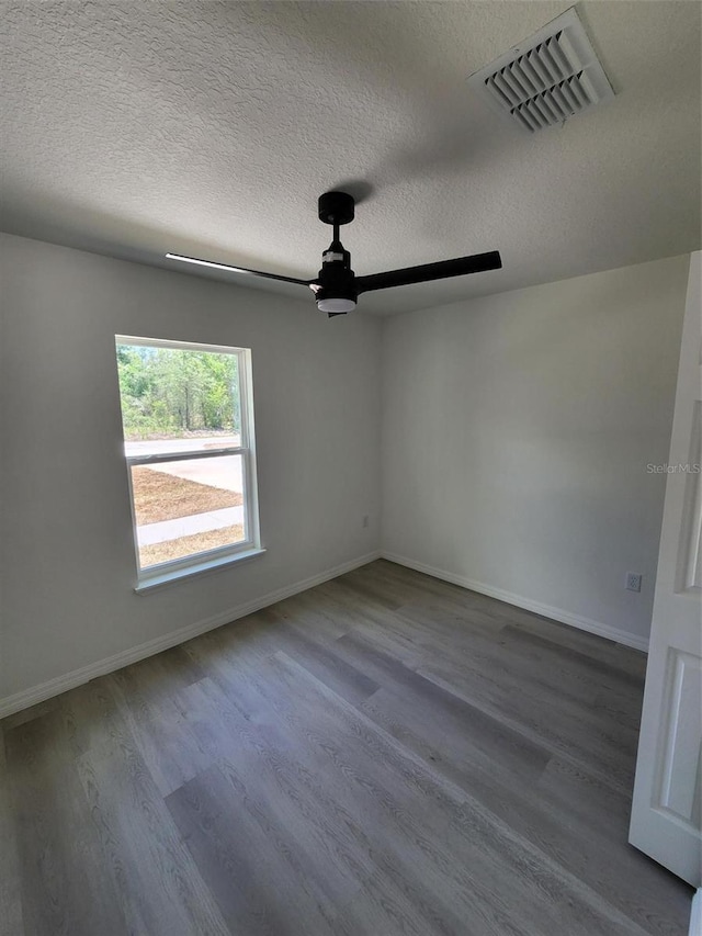 22764 SW Sea Cliff Ave, Dunnellon, FL 34431 - empty room with a ceiling fan, wood finished floors, baseboards, and a textured ceiling