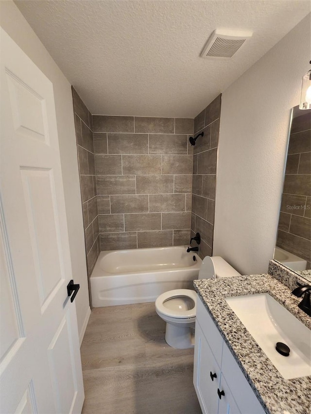 22764 SW Sea Cliff Ave, Dunnellon, FL 34431 - full bath with wood finished floors, toilet, shower / tub combination, a textured ceiling, and vanity