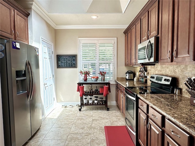 3488 NW 26th St, Gainesville, FL 32605 - kitchen with dark stone countertops, crown molding, backsplash, and stainless steel appliances