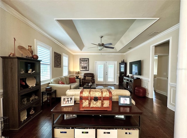 3488 NW 26th St, Gainesville, FL 32605 - living room with a tray ceiling, dark wood-type flooring, ornamental molding, a ceiling fan, and visible vents