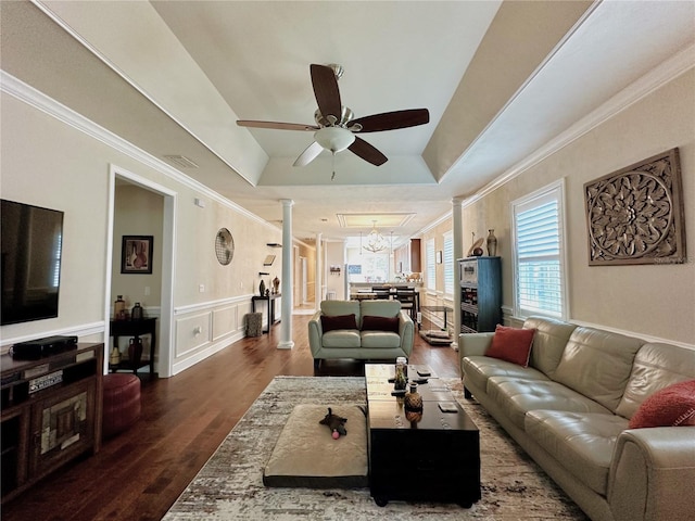 3488 NW 26th St, Gainesville, FL 32605 - living room featuring ornamental molding, dark wood finished floors, a tray ceiling, wainscoting, and ceiling fan with notable chandelier