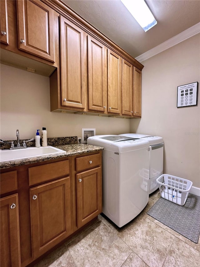 3488 NW 26th St, Gainesville, FL 32605 - laundry area featuring cabinet space, washer and dryer, crown molding, and a sink