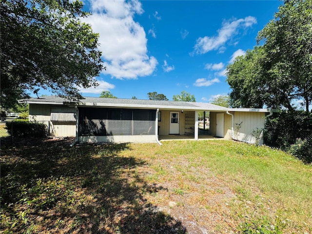 ranch-style home with a front lawn, fence, and a sunroom