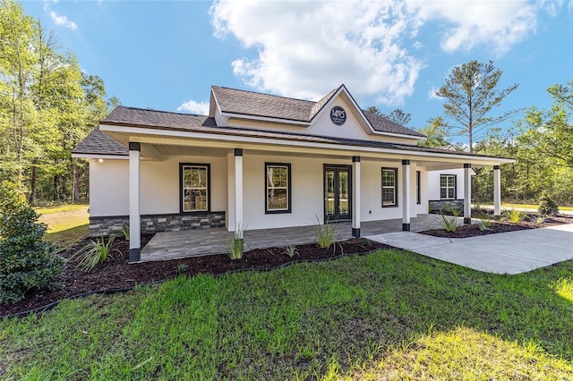 14115 NW 141st Ave, Williston, FL 32696 - view of front facade featuring stucco siding, a front yard, covered porch, and stone siding