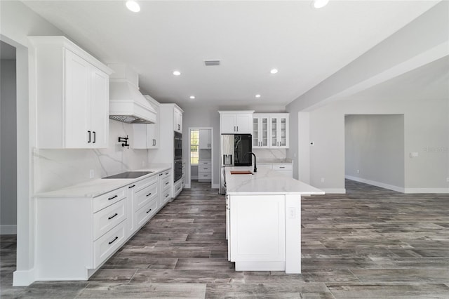14115 NW 141st Ave, Williston, FL 32696 - kitchen featuring custom range hood, recessed lighting, a center island with sink, white cabinets, and dark wood-style flooring