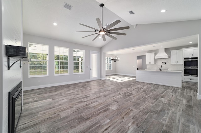 14115 NW 141st Ave, Williston, FL 32696 - unfurnished living room with a ceiling fan, a chandelier, a sink, wood finished floors, and baseboards
