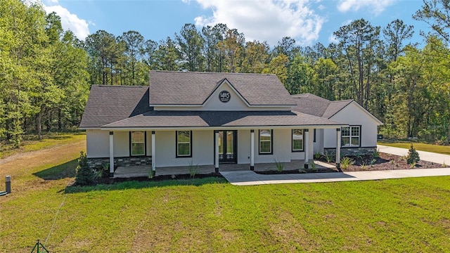 14115 NW 141st Ave, Williston, FL 32696 - view of front of home with stucco siding, a front yard, covered porch, stone siding, and a shingled roof