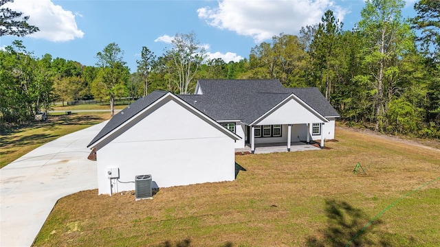 14115 NW 141st Ave, Williston, FL 32696 - view of property exterior with central air condition unit, a lawn, and driveway