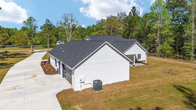 14115 NW 141st Ave, Williston, FL 32696 - view of property exterior featuring driveway, central AC unit, a lawn, and a shingled roof