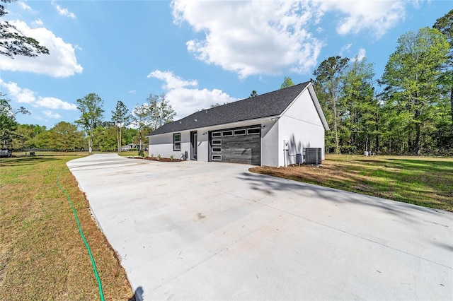 14115 NW 141st Ave, Williston, FL 32696 - view of side of property featuring concrete driveway, stucco siding, central air condition unit, and a lawn