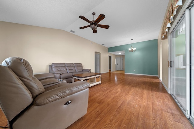 882 Tanglewood Pl, The Villages, FL 32162 - living room featuring ceiling fan with notable chandelier, visible vents, wood finished floors, lofted ceiling, and baseboards