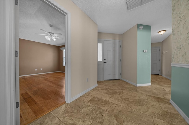 882 Tanglewood Pl, The Villages, FL 32162 - entryway featuring a textured ceiling, baseboards, a ceiling fan, and visible vents
