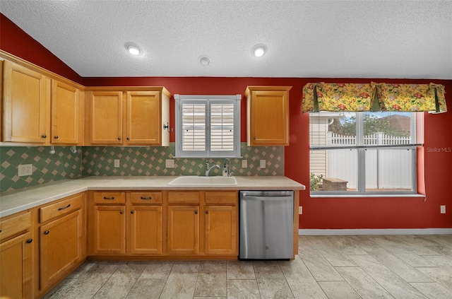 882 Tanglewood Pl, The Villages, FL 32162 - kitchen with light countertops, backsplash, a textured ceiling, stainless steel dishwasher, and a sink