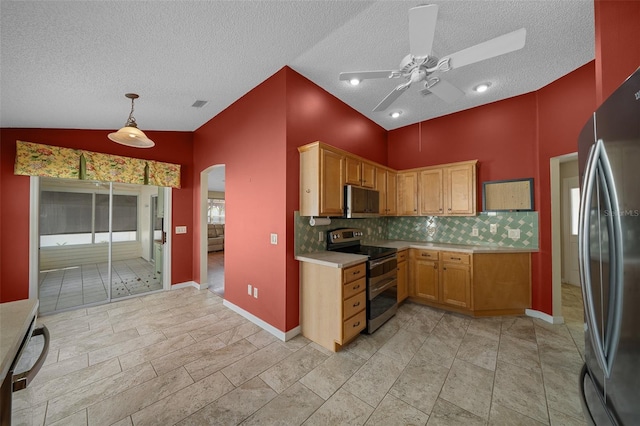 882 Tanglewood Pl, The Villages, FL 32162 - kitchen with ceiling fan, a textured ceiling, arched walkways, appliances with stainless steel finishes, and light countertops