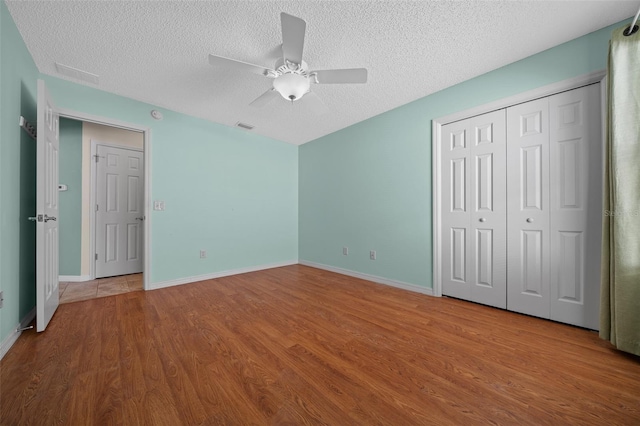 882 Tanglewood Pl, The Villages, FL 32162 - unfurnished bedroom featuring visible vents, a textured ceiling, and wood finished floors