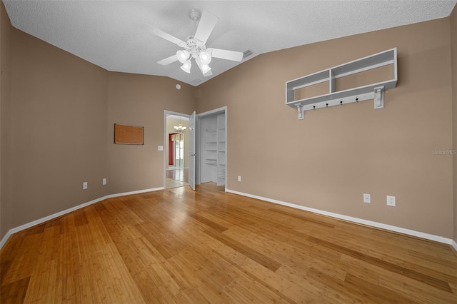882 Tanglewood Pl, The Villages, FL 32162 - spare room featuring ceiling fan with notable chandelier, light wood-type flooring, visible vents, lofted ceiling, and baseboards