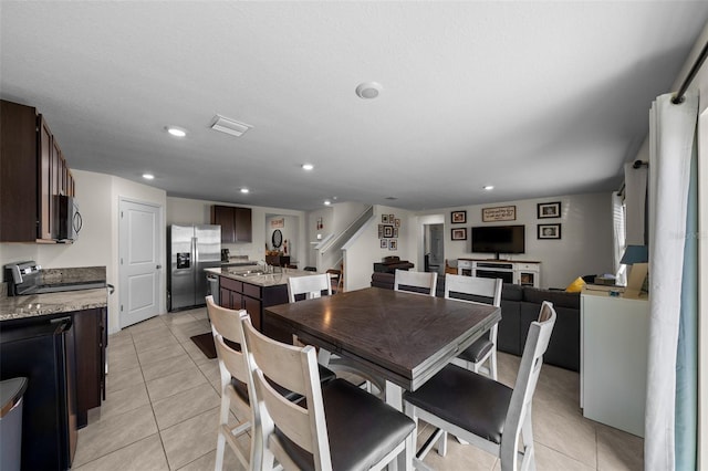 dining area featuring visible vents, stairway, light tile patterned flooring, and recessed lighting