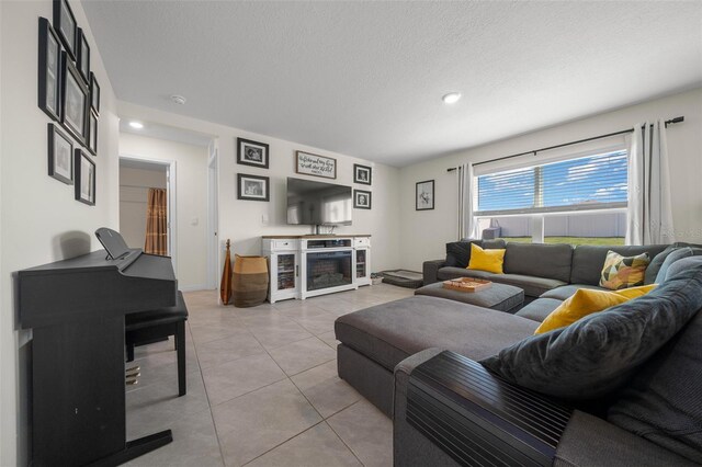 living room with recessed lighting, light tile patterned flooring, and a textured ceiling