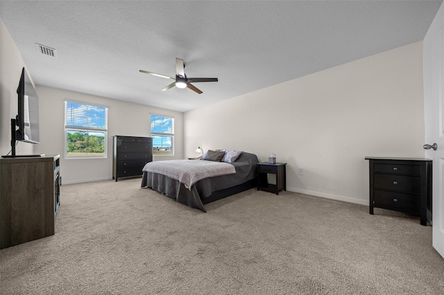 carpeted bedroom featuring ceiling fan, baseboards, and visible vents