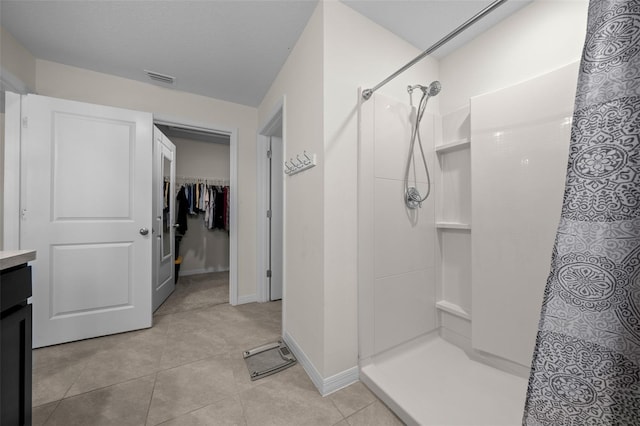 full bathroom with a shower stall, tile patterned flooring, and visible vents