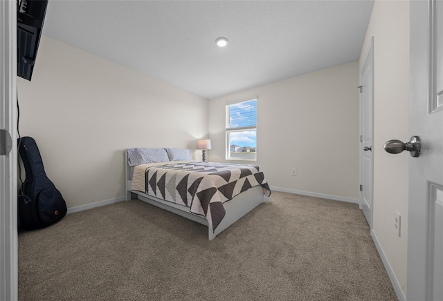 bedroom with baseboards and carpet