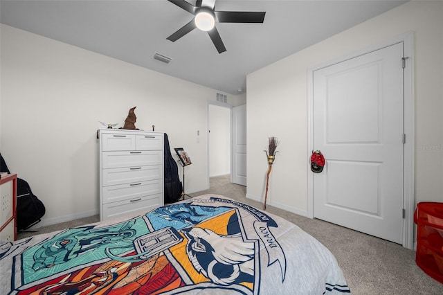 bedroom featuring visible vents, baseboards, a ceiling fan, and light carpet
