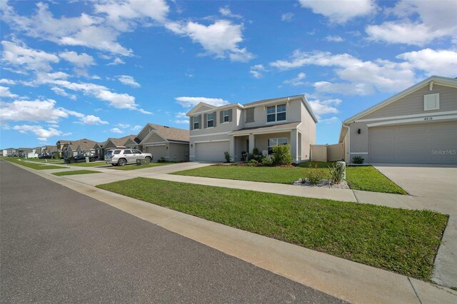 traditional-style home featuring a residential view, stucco siding, driveway, a front lawn, and a garage