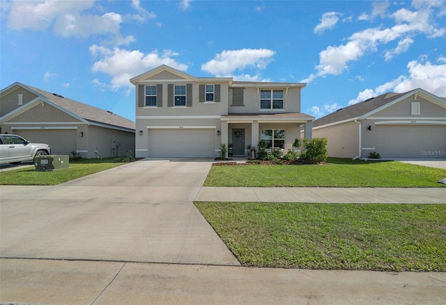 traditional-style house with an attached garage, concrete driveway, stucco siding, and a front yard