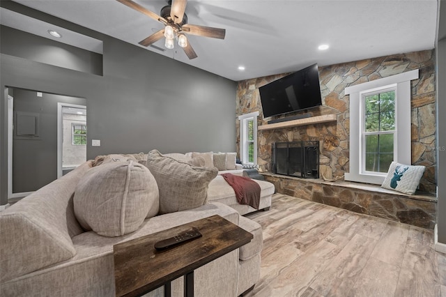living room with ceiling fan, recessed lighting, wood finished floors, and a fireplace