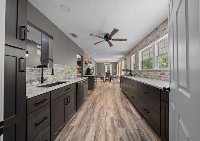 kitchen featuring light wood-style floors, dark brown cabinets, a ceiling fan, a sink, and backsplash