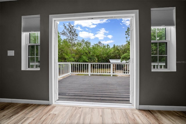 entryway with wood finished floors and baseboards