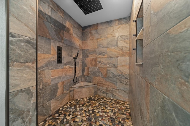 full bath with a tile shower