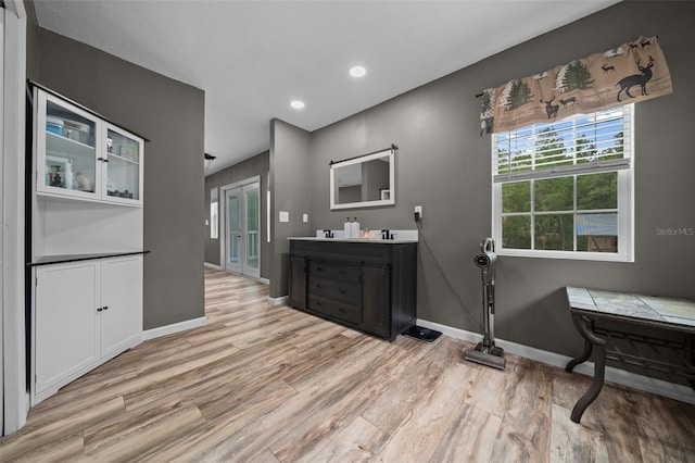 interior space with recessed lighting, light wood finished floors, and baseboards