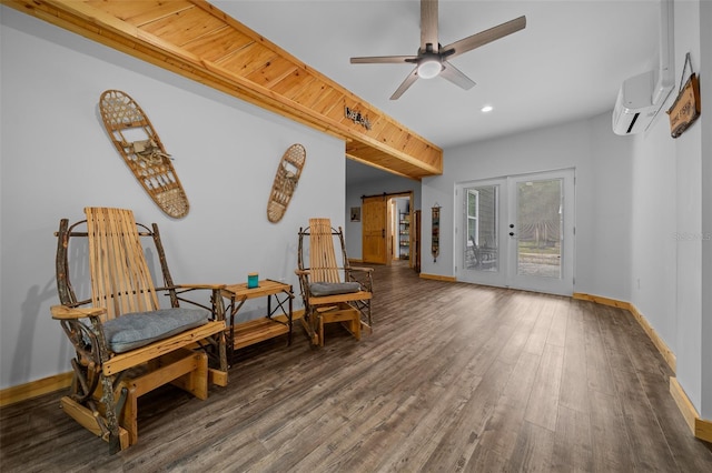 sitting room with a ceiling fan, recessed lighting, wood finished floors, an AC wall unit, and baseboards