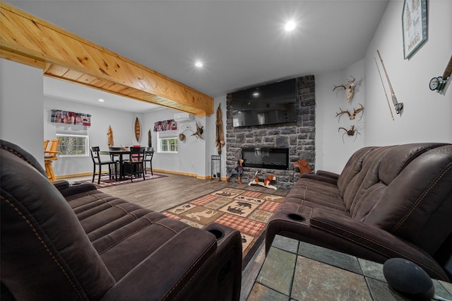 living area featuring baseboards, recessed lighting, wood finished floors, and a fireplace