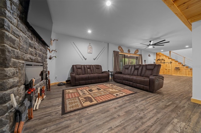 living area with ceiling fan, stairway, wood finished floors, and baseboards