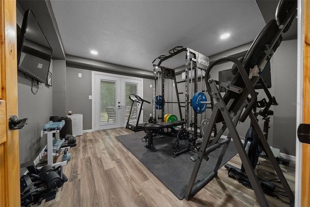 workout room featuring french doors, wood finished floors, baseboards, and recessed lighting